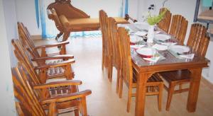 a dining room with a wooden table and chairs at Winter Dream Holiday Bungalow Nuwara Eliya in Nuwara Eliya