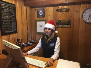 a girl wearing a santa hat sitting at a desk with a laptop at Cabañas El Estribo Hotel in Valle de Bravo