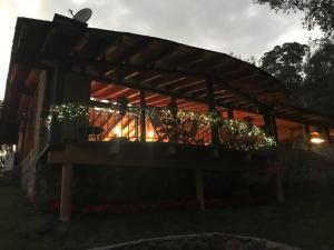a wooden pergola with christmas lights on it at Cabañas El Estribo Hotel in Valle de Bravo