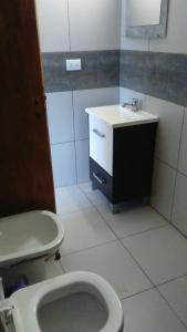 a bathroom with a toilet and a sink at Apartamentos Croacia del Mar in Santa Clara del Mar +19 photos