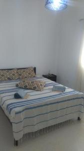 A bed or beds in a room at Appartement à Houmt Souk Jerba