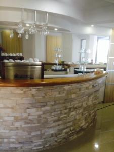 a bar in a restaurant with a brick wall at Apartments Croma in Ulcinj +21 photos