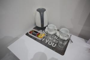 a table with four glasses and a blender at Apollo Rooms by Albert's Apartment in Larnaka