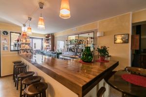 a bar with a large wooden counter in a restaurant at Hotel Faggio Rosso in Pescasseroli