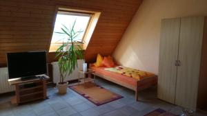 a small room with a bed and a television at Martinas-Gästehaus in Hornbach