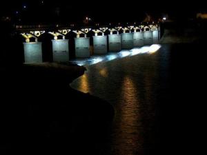 a row of lights on the water at night at Casa Feijao - Alojamento Local in Geres