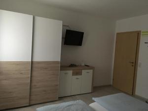 a living room with a tv and a cabinet at Ferienwohnung Wittenburg in Hermagor