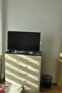 a dresser with a television on top of it at TOP CENTER , MODERN AND QUIET APARTMENT in Burgas