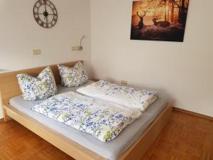 a bed with blue and white sheets and pillows at FeWo Darsberg in Neckarsteinach