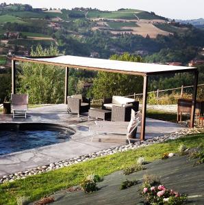 a patio with a gazebo and a pool at Agriturismo CasaMatilda in Dogliani