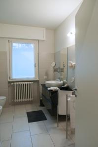 a bathroom with a sink and a toilet and a window at Relais Merizzi in Tirano +31 photos