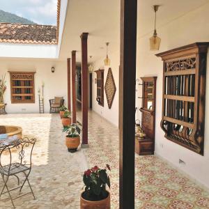 a courtyard of a house with potted plants at Casa Passiflora Hotel Boutique by HMC in Jardin
