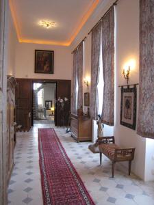 a hallway with a living room with a rug at Château de Flée in Semur-en-Auxois