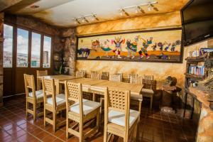 a dining room with a wooden table and chairs at Hotel Rosario La Paz in La Paz