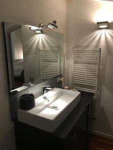 a bathroom with a white sink and a mirror at Modena Charme in Modena