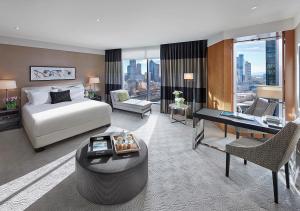 a hotel room with a bed and a desk at Crown Towers Melbourne in Melbourne +26 photos