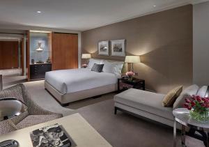 a hotel room with a bed and a couch at Crown Towers Melbourne in Melbourne
