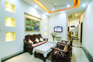 a living room with a couch and a table at Countryside Garden Homestay in Hoi An