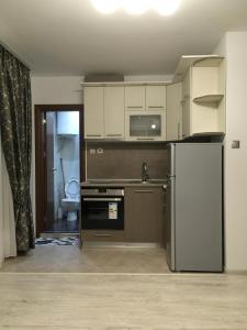 a kitchen with a refrigerator and a stove top oven at Apartment Park Sveti Vrach in Sandanski