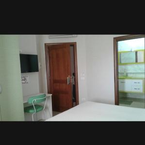 a bedroom with a bed and a desk and a window at Sweet Home in Falerna