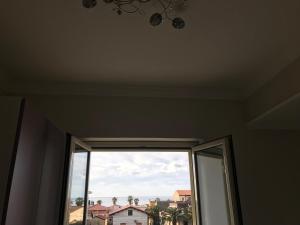 a window in a room with a view of a house at Sweet Home in Falerna