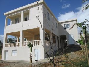a large white building with a balcony on the side at Villa Mambo in Patrana