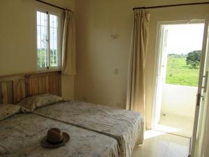 a bedroom with a bed with a hat on it at Villa Mambo in Patrana