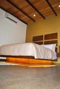a bedroom with a bed with a wooden bed frame at The Canoe in Negombo