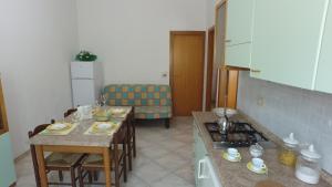 a kitchen with two tables and a stove top oven at International Camping Village in Praia a Mare