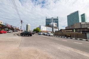 a city street with cars parked on the side of the road at G3 HOUSE in Johor Bahru