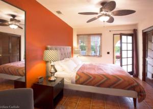 a bedroom with a bed and a ceiling fan at Villa Cristine - Spanish Style Palm Springs Villa in Palm Springs +54 photos