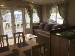 a living room with a couch and a table at Tattershall lakes in Tattershall
