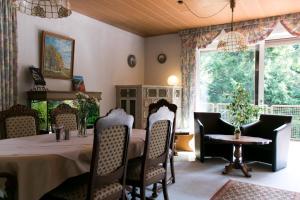 a dining room with a table and chairs and a window at Haus am Wasserfall in Detmold