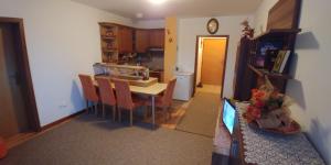 a kitchen and dining room with a table and chairs at Lux - Apartment Snow Oasis in Vlasic