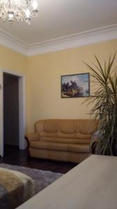 a living room with a couch and a painting on the wall at Smile Khreschatyk Kyiv in Kyiv