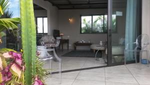 a view of a living room with a glass door at Apartment Atrium in Grand Baie