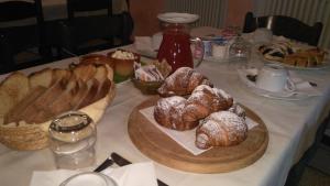 a table with croissants and pastries on it at Agriturismo Taglio del Re in Jesolo