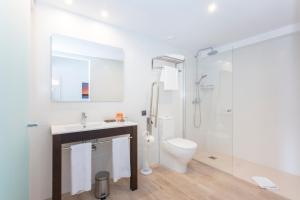 a white bathroom with a shower and a toilet at Mar Hotels Alcanada in Port d'Alcudia