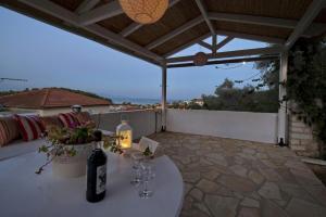 a white table with wine glasses on a patio at Harry's Studios 1 in Gaios