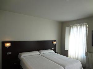 Łóżko lub łóżka w pokoju w obiekcie Hotel Irixo