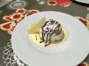 un piatto bianco con un dessert su un tavolo di La Valle dei Fiori di Bellucci Rosanna a Torre deʼ Calzolari