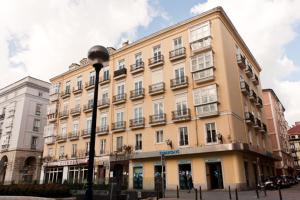 a large building on a city street with a street light at Plaza Pombo B&B - Hostal in Santander
