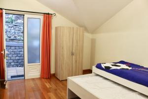 a bedroom with a bed and a sliding glass door at Pink House in Ponta do Sol