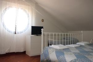 a bedroom with a bed and a window at Mimì e Cocò Country House in Ascoli Piceno