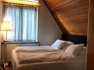 a bedroom with a large bed with a window at Apartments Ålholmvej in Copenhagen