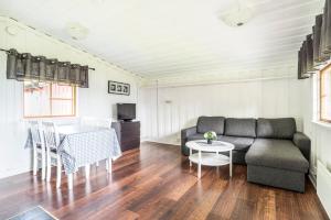 a living room with a couch and a table at First Camp Frösön-Östersund in Frösö