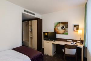 Postel nebo postele na pokoji v ubytování Hotel Esplanade Dortmund