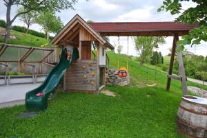 a small playground with a slide and a play structure at Kornihof in Waidhofen an der Ybbs