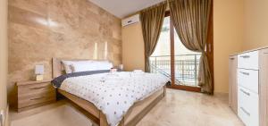 a bedroom with a bed and a large window at Apartments Residence Portofino in Kotor