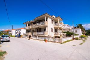 a large white house on the side of a street at Villa Angel in Limenas